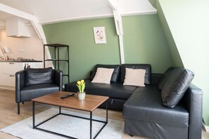 Bright and inviting seating area with a view towards the dining and kitchen space and window. 
