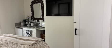 Queen bedroom suite, smart TV,  kitchenette, bathroom behind barn door.