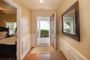 Bright entrance with a bench to sit and remove shoes and feel at home.