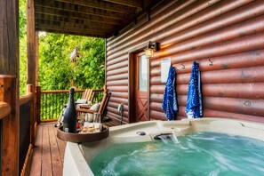 The hot tub is located on the lower deck and is easily accessible through the camp room.