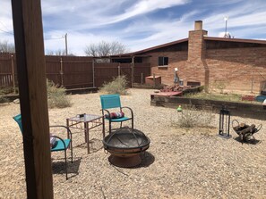 View of firepit and main house from the kitchen window