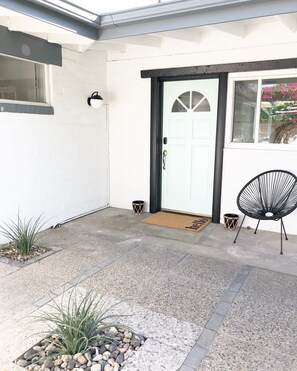 Front door, within the exterior privacy wall.
