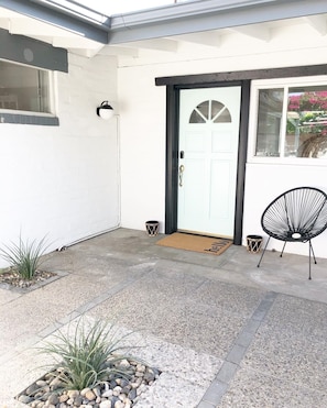 Front door, within the exterior privacy wall.
