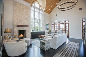 The Great Room boasts a grand staircase with custom iron railing