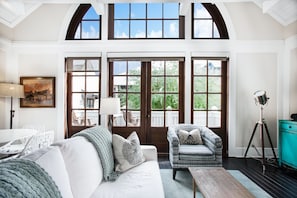 Large windows flood the stylish living area with natural light.