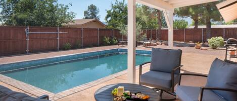 Relax in the shade by the pool on cushy patio furniture that literally rocks