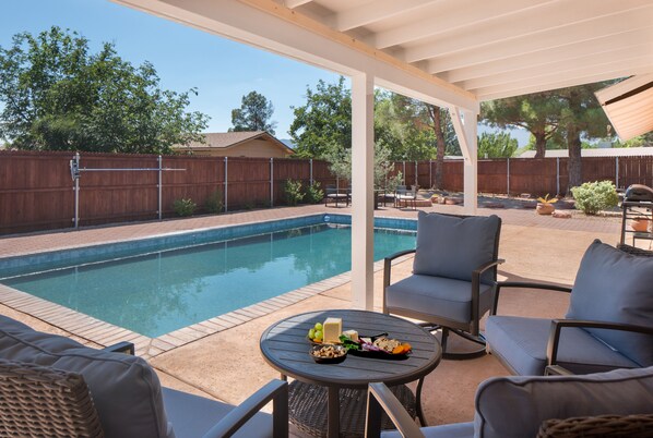 Relax in the shade by the pool on cushy patio furniture that literally rocks