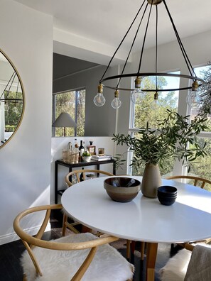 Natural light envelopes the dining area w/ views of the mountains. Bon Appetit!