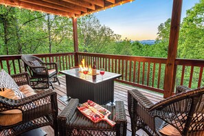 Cozy up to the fire pit while taking in the spectacular Smoky Mountain views.