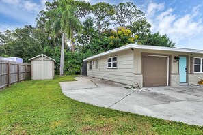 1 car garage with Laundry, beach chairs, coolers, dog crate, & beach towels