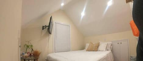 Queen size bed, TV, WiFi, 2 deep storage closets, a dresser, small end table, a shelf & stool