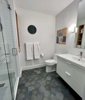 Sumptuous tiled bathroom with large vanity and shower. 