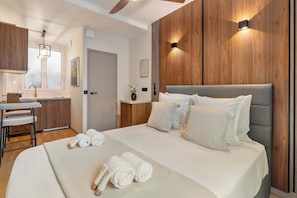 Snug queen size double bed with ceiling fan and storage.
