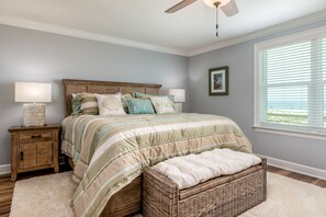 Primary bedroom, located upstairs with ensuite. King bed. Unobstructed beach views