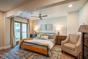 King size bed in master with sliding glass door to a Juliette balcony.