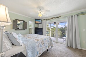 Master bedroom and balcony overlooking the private snorkeling lagoon