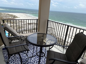 Relax on your private balcony with mesmerizing views of Orange Beach.