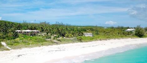 This private estate looks out over a pristine, mile-long pink-sand beach.