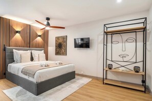 This room comes with a Queen-size bed, ceiling fan, and storage for convenience.