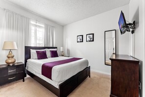 The upstairs queen-size bedroom is decorated in purple and is a cozy, spacious.