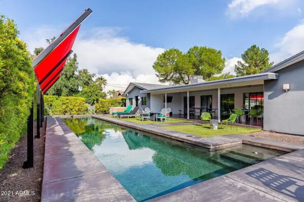 Large lap pool w/ water fountain, multi-colored LED night lights, & shade.