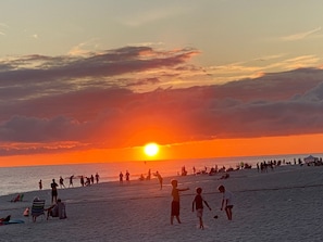 Enjoy the sun setting over the white sand beach