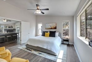 The cheery master bedroom offers views of the mountainside behind the home.