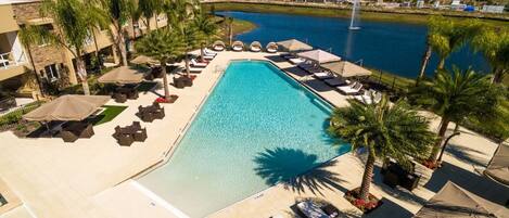 Large swimming pool with loungers and umbrellas