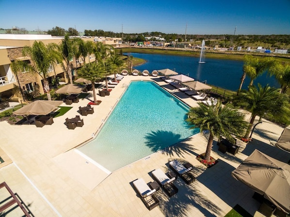 Large swimming pool with loungers and umbrellas