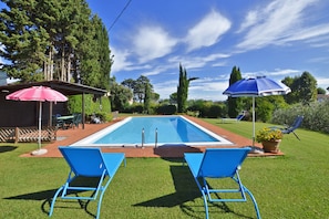 The equipped pool and the nice and wide surrounding lawn