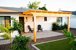 Wooden pergola and front patio seating 