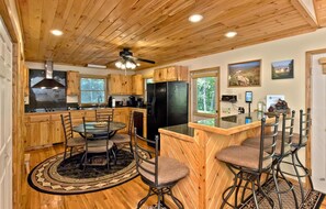 The large eat-in kitchen offers plenty of space to prepare and enjoy meals together. Additional seating is available at the counter for larger groups.