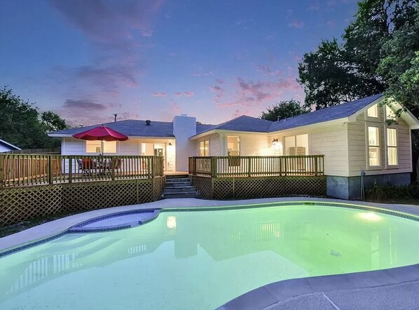 Swimming pool off of the backyard fenced patio, now with a child safety fence.