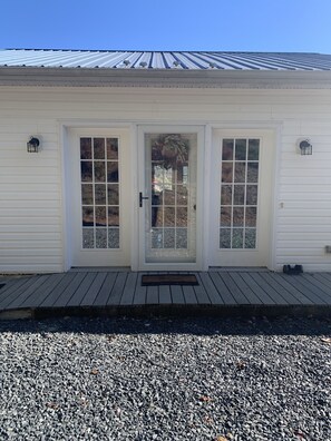 Back door entrance on the gravel driveway.