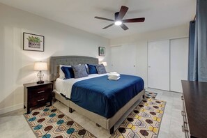 Primary bedroom with a king size bed and it's own smart television.  Attached bathroom as well