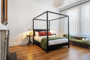 The spacious main bedroom features a queen bed and a chaise lounge as well as a traditional wardrobe for your belongings.