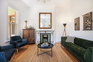 This elegant home offers velvet sofas in the living room under a pretty chandelier. The fireplace is only ornamental but central heating is available throughout.
