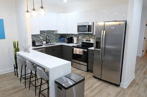 Kitchen island / breakfast bar doubles as a laptop friendly workspace