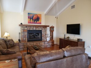 Living room with gas fireplace and Roku TV with Hulu