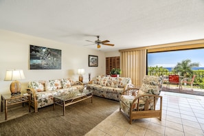 Spacious and comfortable living room area with ocean views