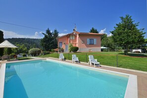 The property, the pool and the private garden surrounding