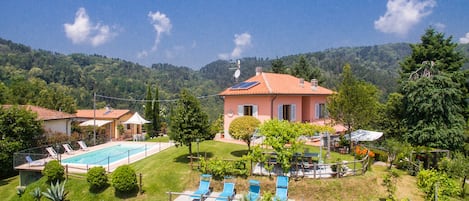 The property, the pool and the private garden surrounding