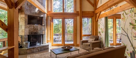 Main level living room with wood burning fireplace.