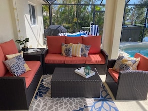 Comfortable lanai - partially covered with a ceiling fan and eating area.