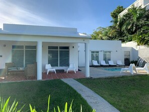 Front of house. High top table to left of veranda for eating or teleworking.