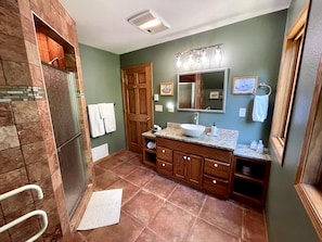 Spacious bathroom granite countertops two large windows brings a lot of light overlooking firepit. Large Italian Marble walk in shower, provided toiletries   *note this is the upper loft level must take stairs to access* bedroom is main entry level * 