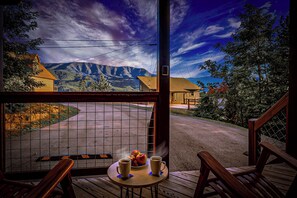 Imagine standing on a spacious wooden deck, nestled high in the mountains 