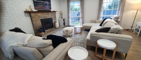 Open plan lounge with adjustable couches, gas log fire, free pay TV, board games