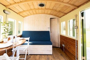 The lounge area has a dining table and clever seating area that transforms into bunk beds.