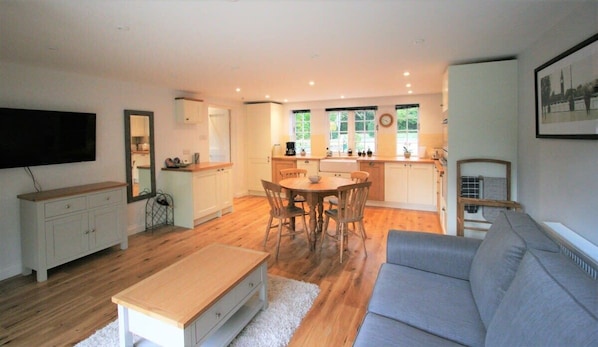 There is a fully equipped kitchen with butler sink and dishwasher